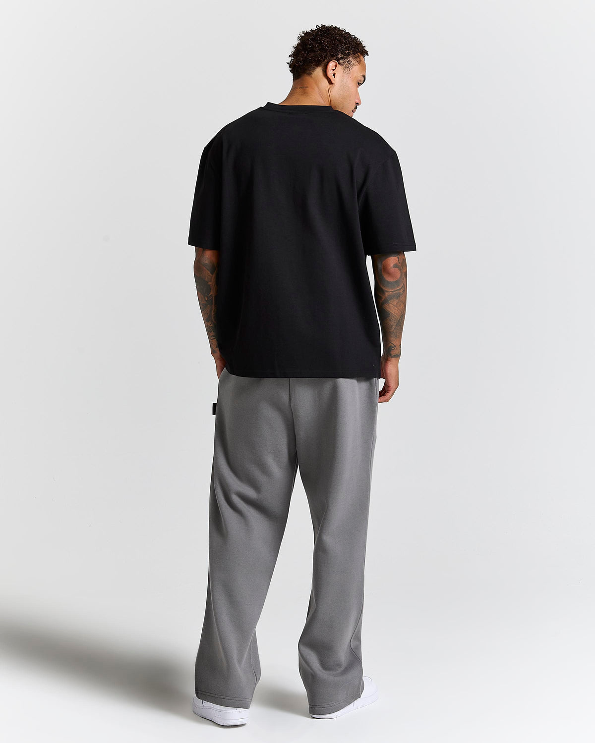 Displays a model wearing the Black lava smoke 'Hoodrich' branded Forza Oversized T-shirt