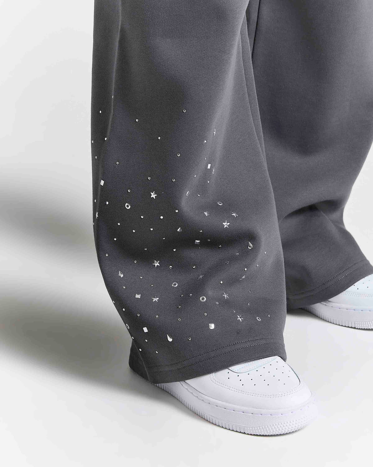 Displays a model wearing the grey 'Hoodrich' branded women's Clash Full Tracksuit