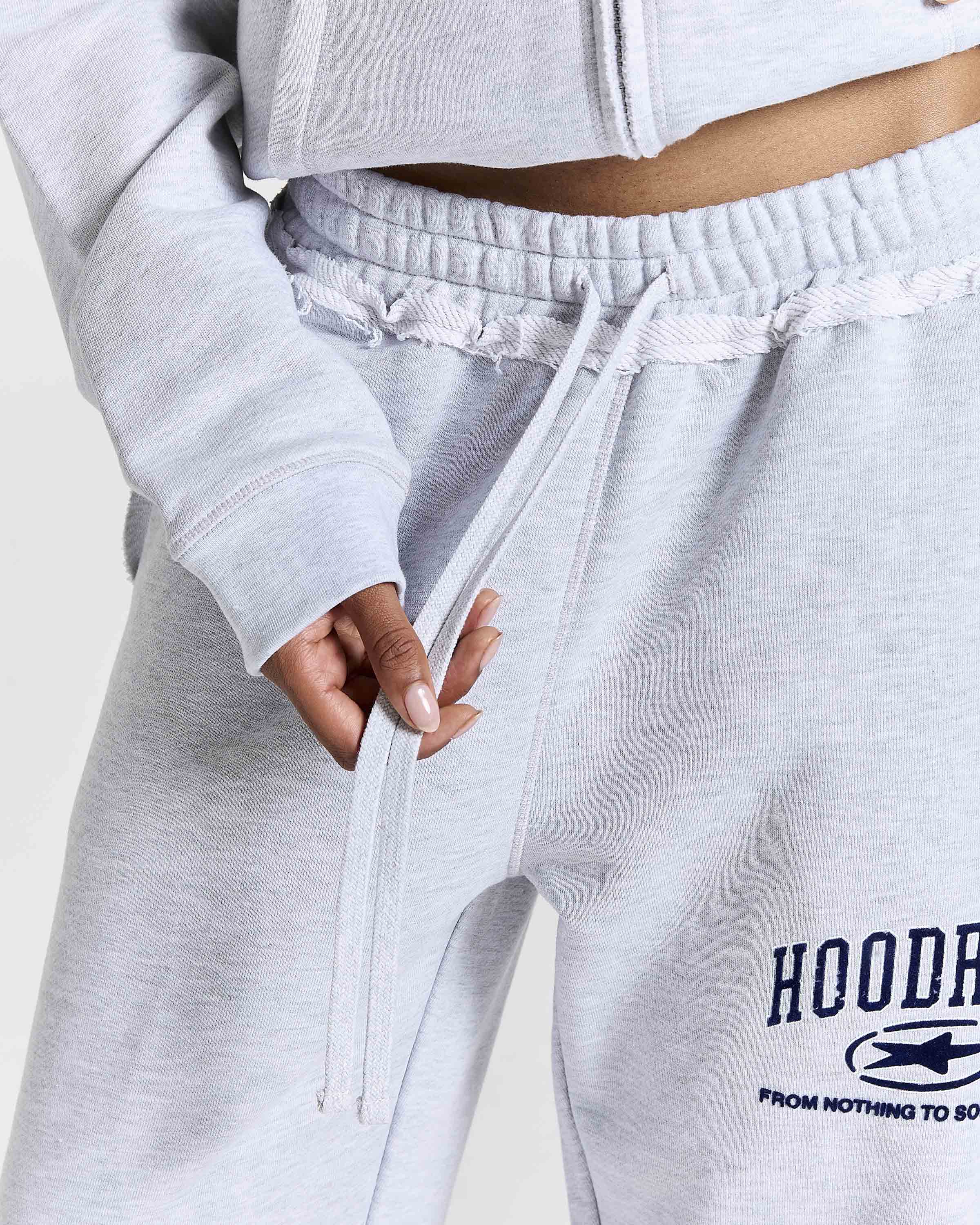 Displays a model wearing the Grey 'Hoodrich' branded Women's Frey Full Tracksuit