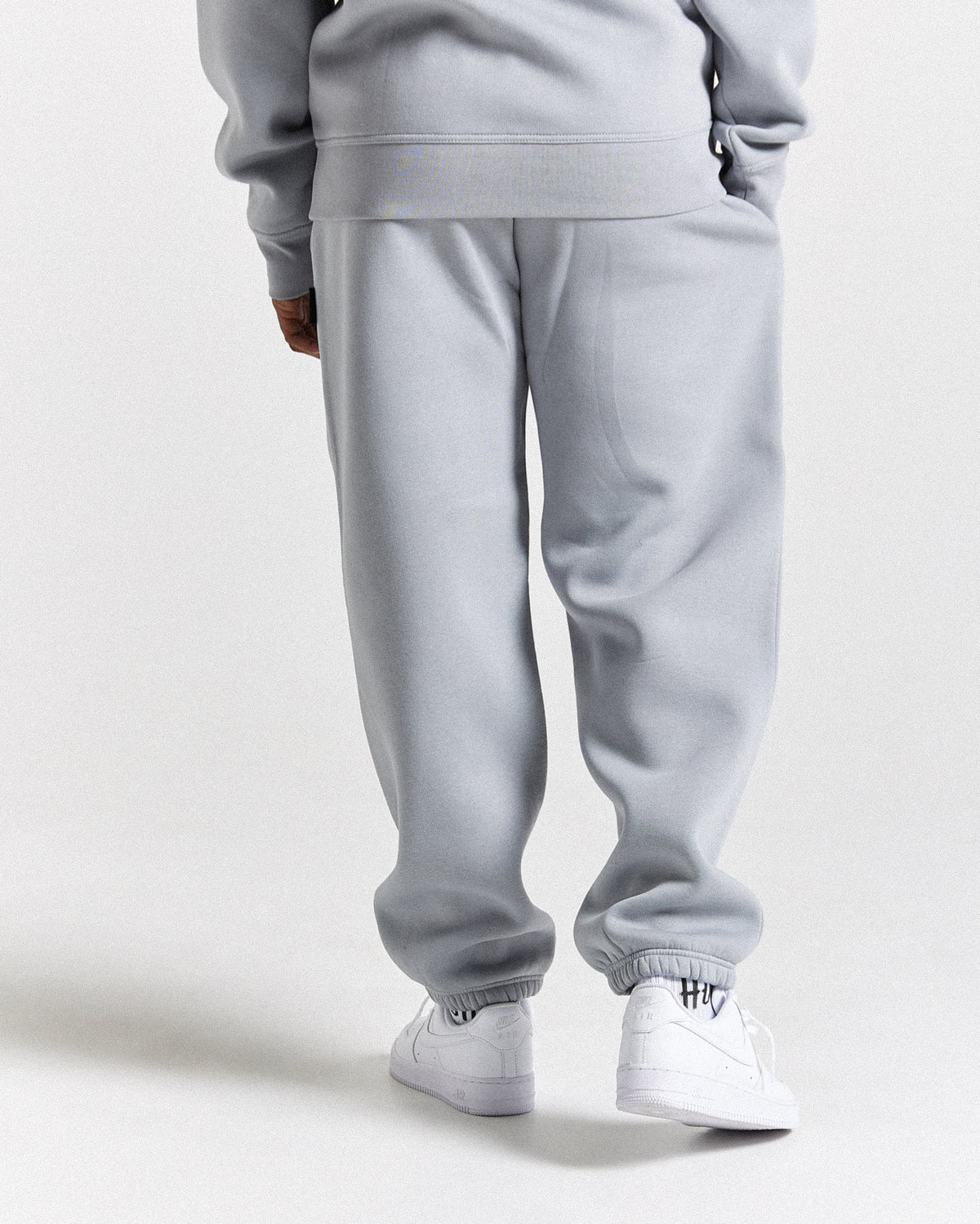 Displays a model wearing the Grey 'Hoodrich' branded men's Dark Full Tracksuit
