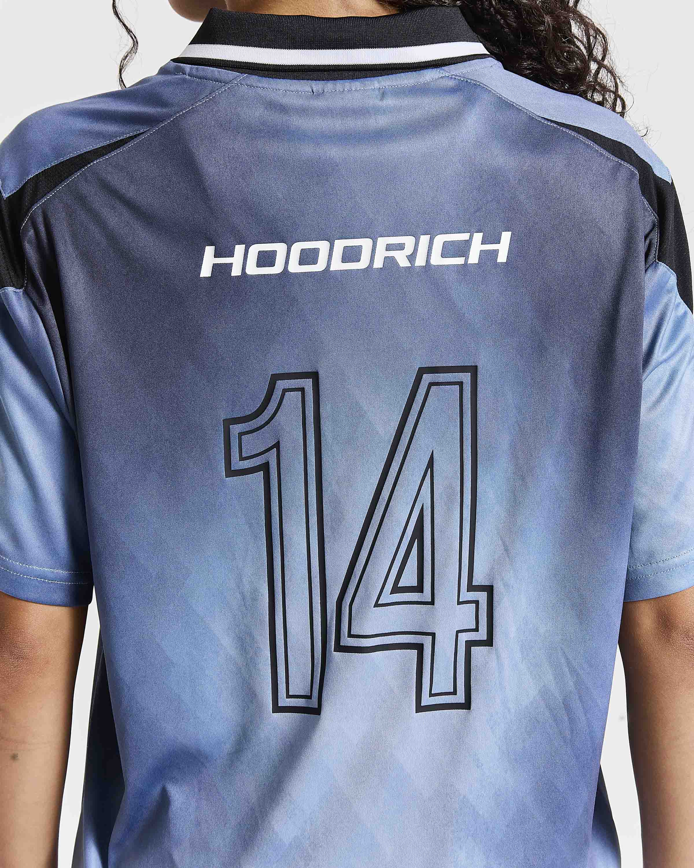 Back view of a light blue and gray soccer jersey with 'HOODRICH' and the number '14' printed on the back, worn by a model.
