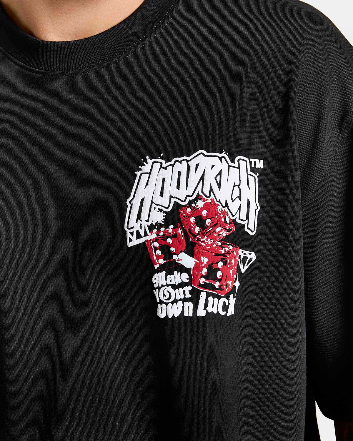 Displays a model wearing the Black 'Hoodrich' branded Fortune Oversized T-Shirt featuring the details on the logo