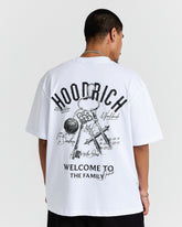 Person wearing a white t-shirt with black graphics and text on a plain background