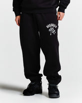 Person wearing black sweatpants with a logo on a white background