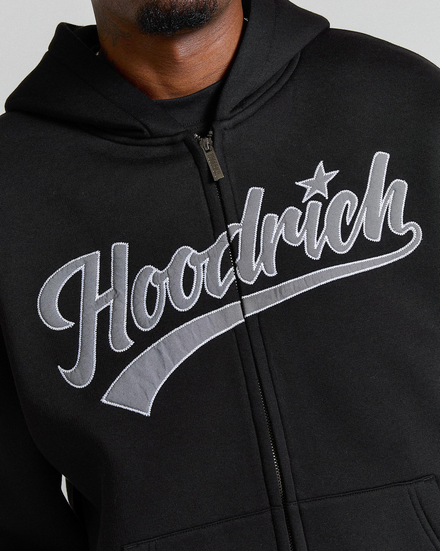 Black hoodie with 'Hoodrich' logo on a gray background