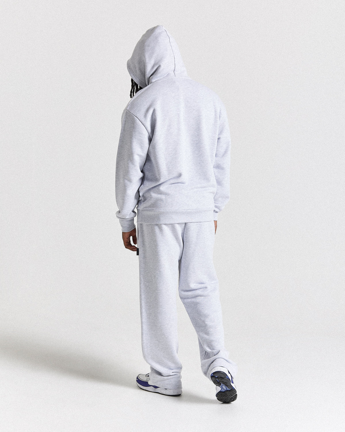 Displays a model wearing the light grey 'Hoodrich' branded men's Asthrich Full Tracksuit 