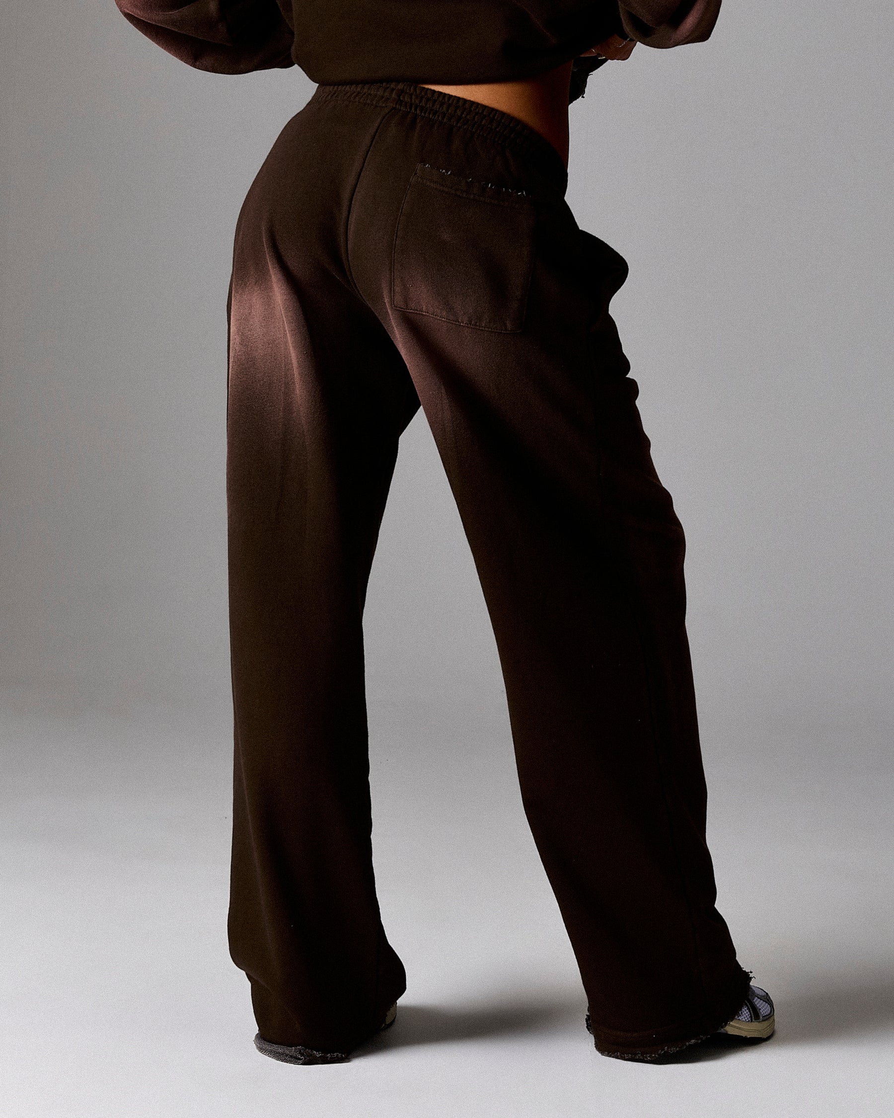 Brown wide-leg pants worn by a person on a plain background