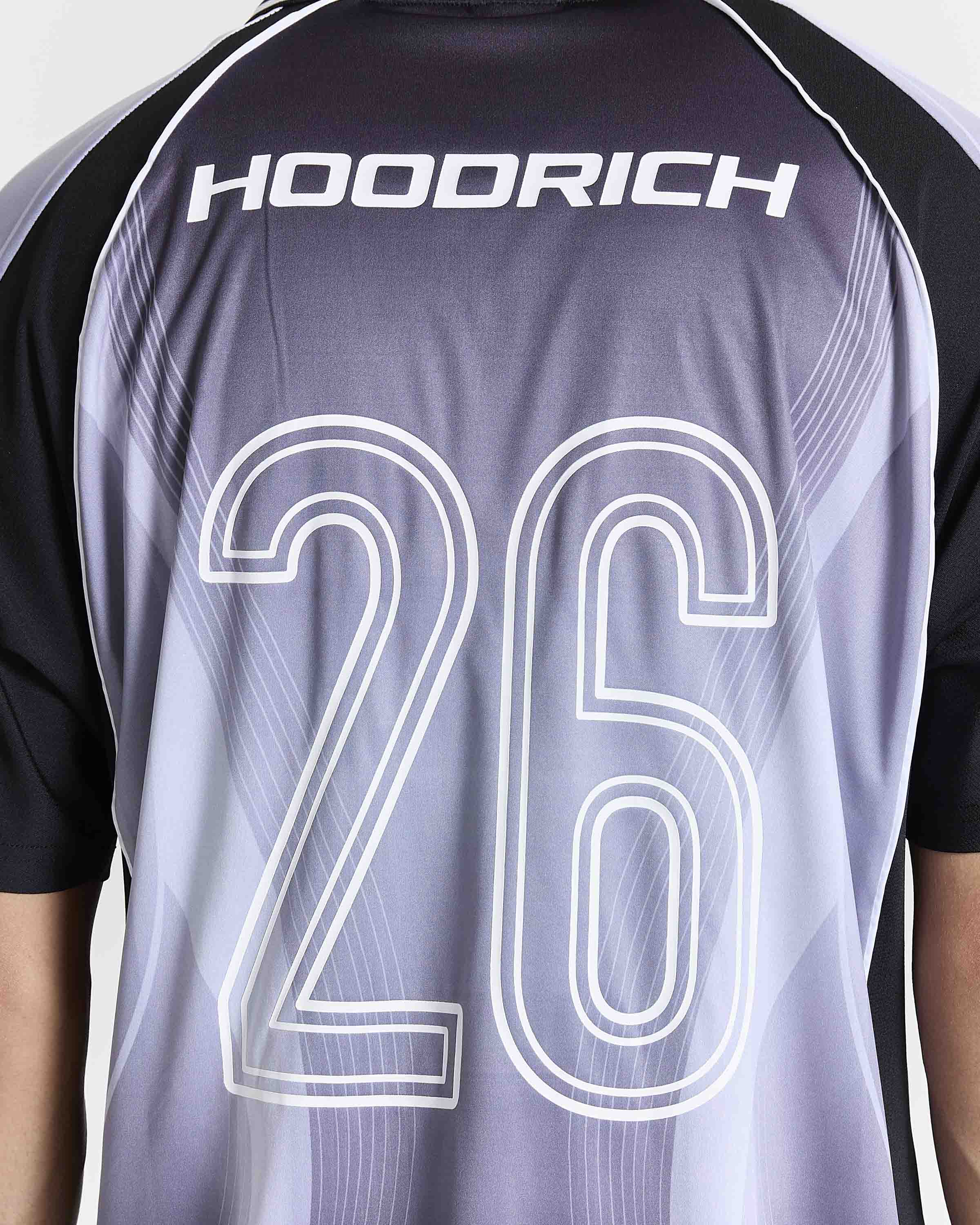 Close-up of the back of a short-sleeve athletic jersey with the brand name HOOORICH across the upper back and the number 26 outlined in white. The jersey has a gray-to-white gradient body with black sleeves and shoulder panels.