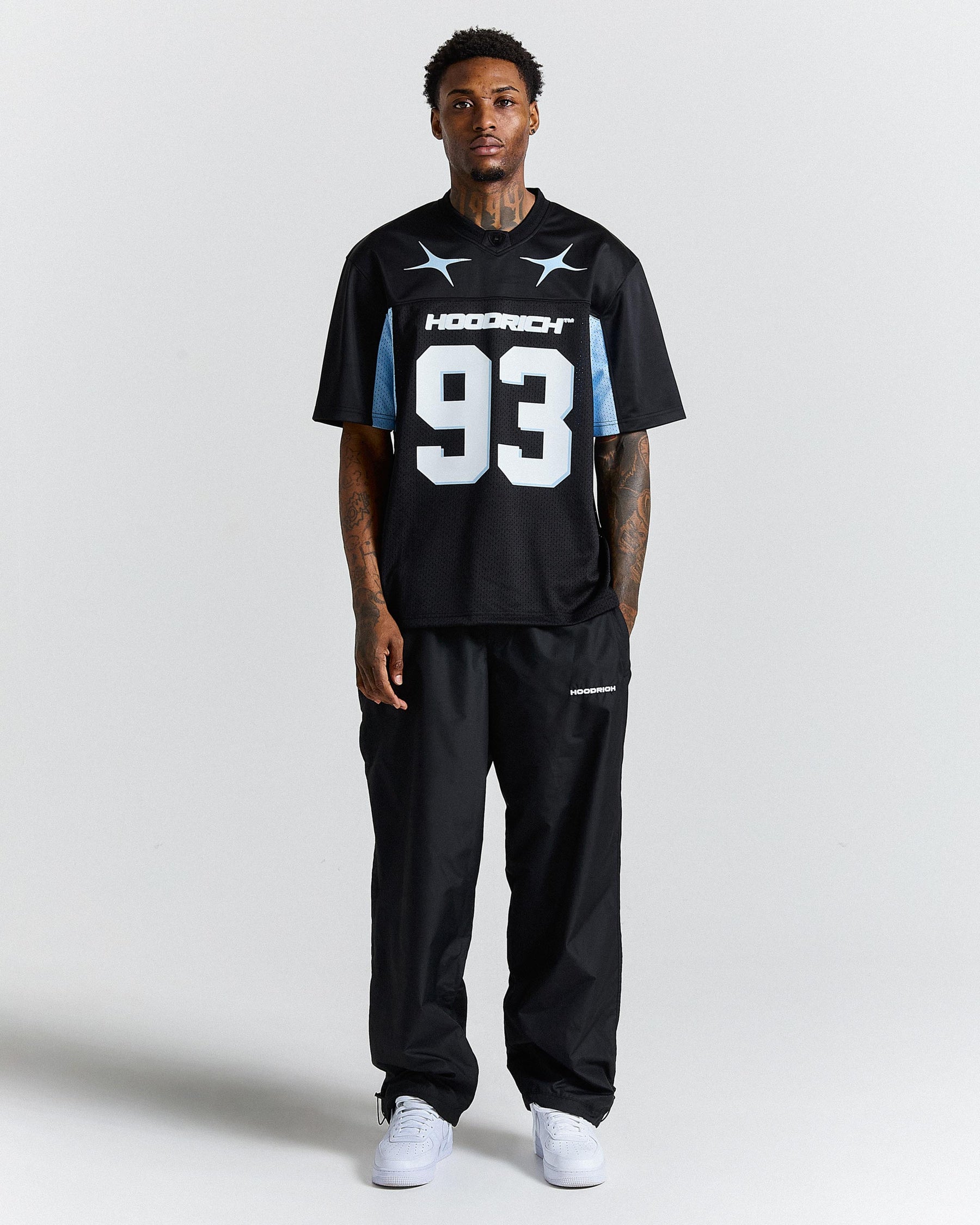 Person wearing a black sports jersey with the number '93' on a white background