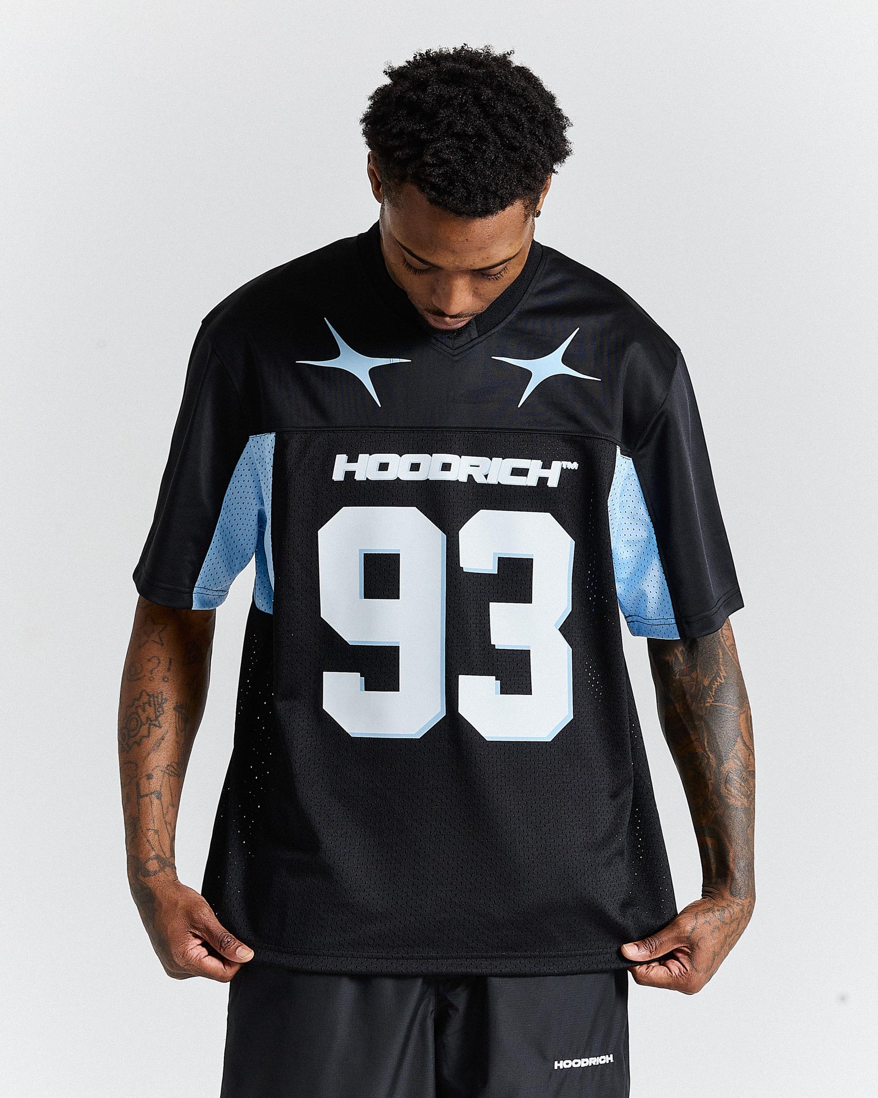 Person wearing a black sports jersey with the number 93 and 'Hoodrich' branding on a white background