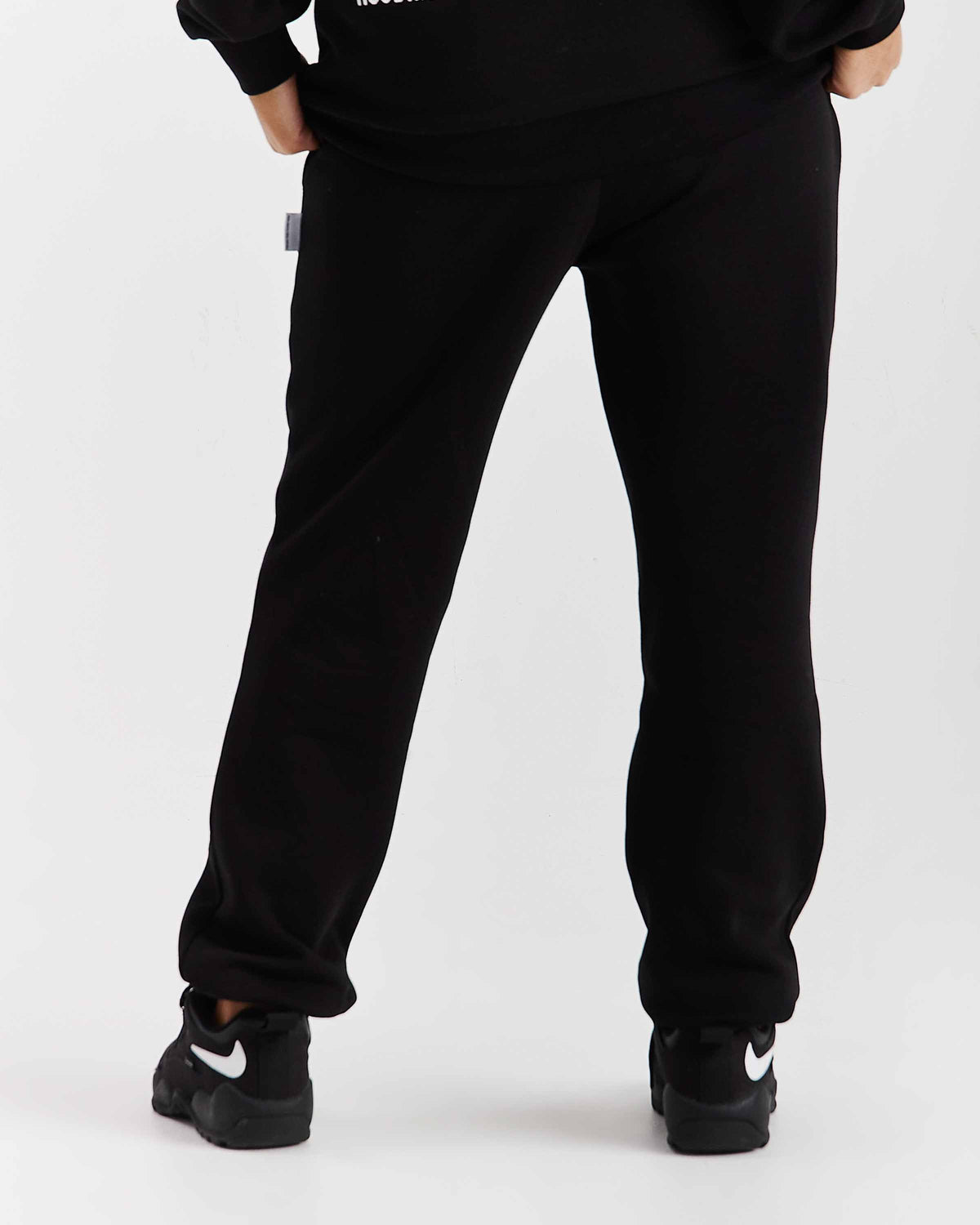 Displays a model wearing the Black 'Hoodrich' branded women's Flex Full Tracksuit 