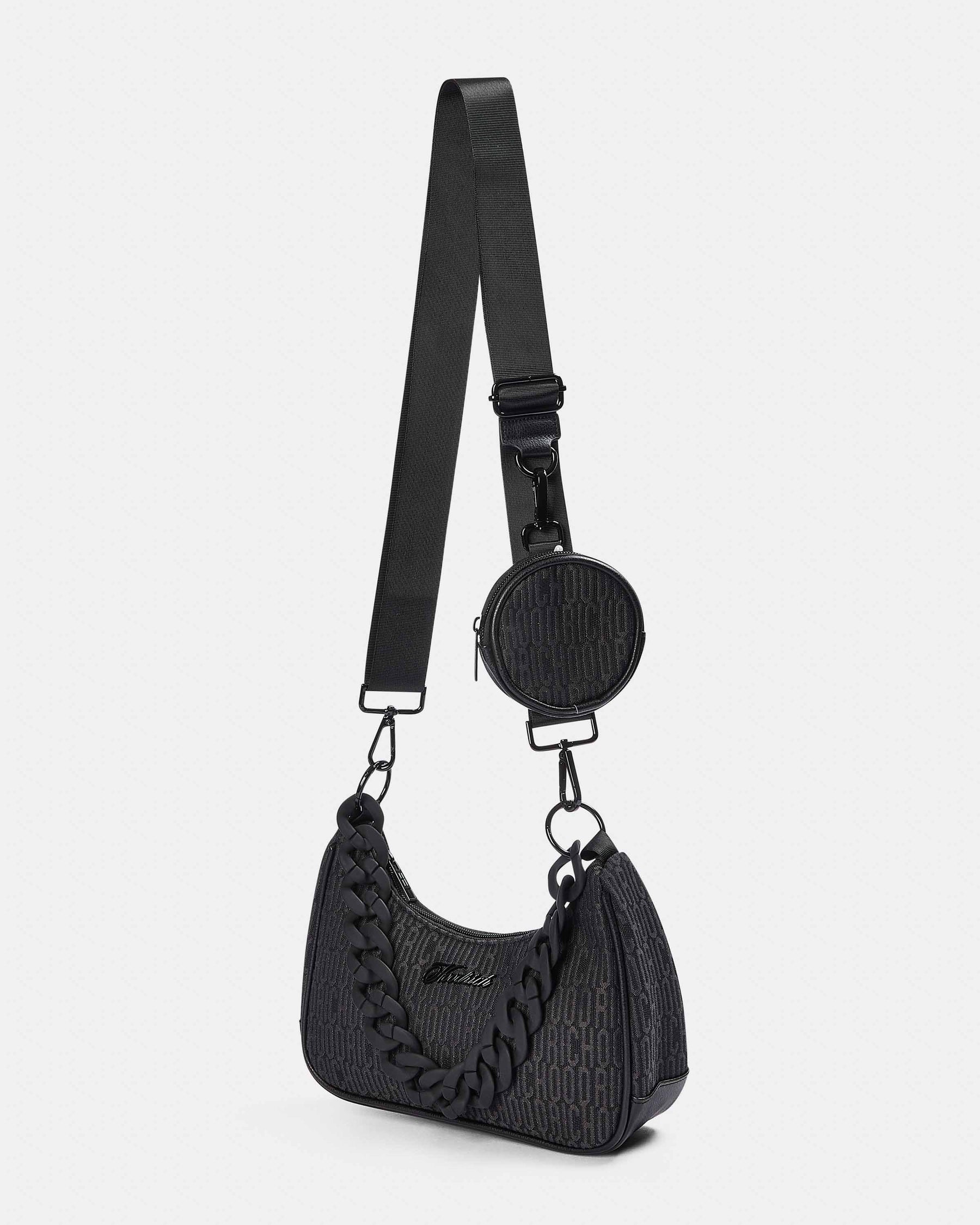 Black textured handbag with a matching round coin purse on a white background