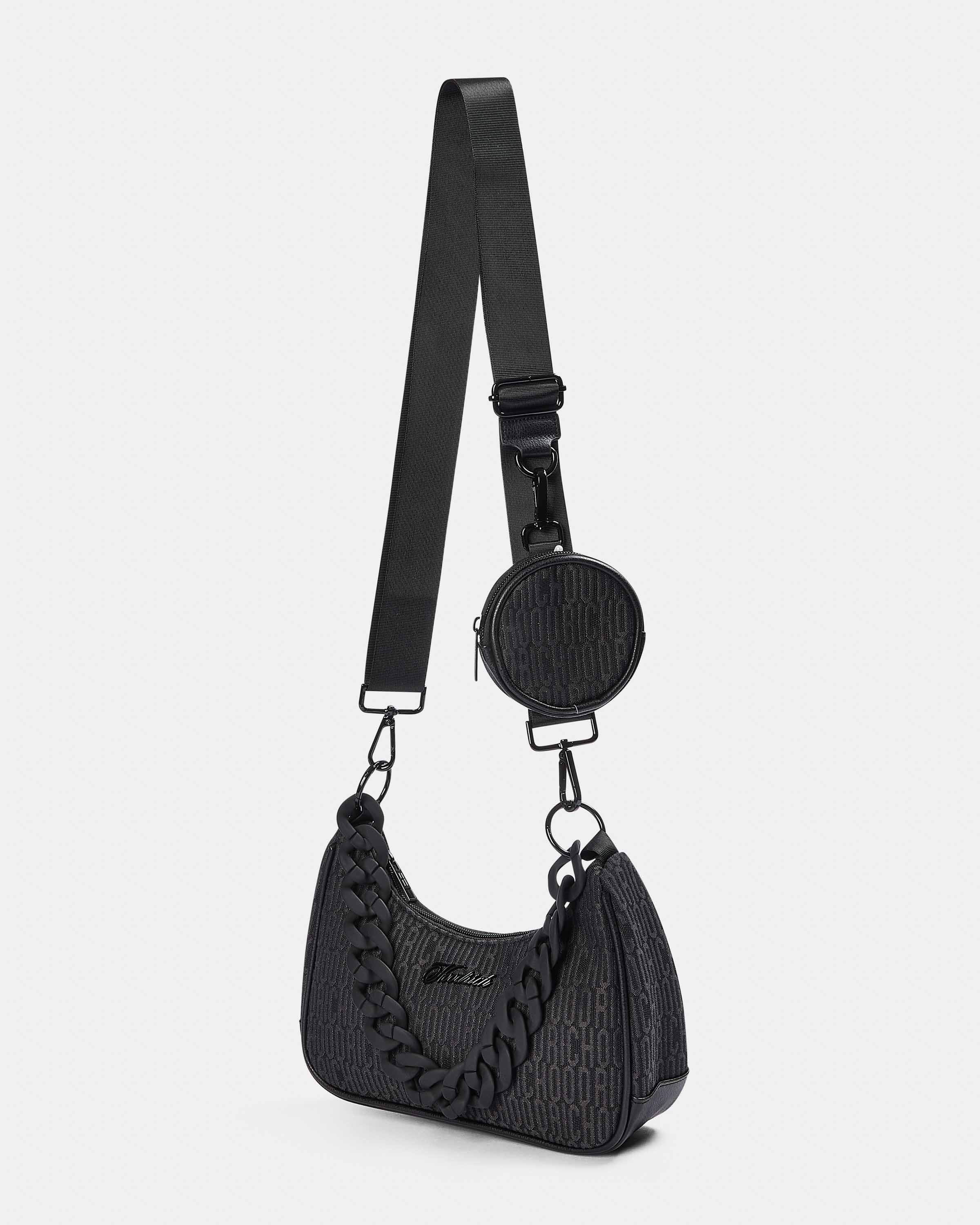 Black textured handbag with a matching round coin purse on a white background
